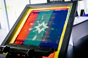 T-shirt printing press with the Starlight logo design.