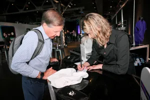 A guest putting in their order for a printed t-shirt at the swag bar.