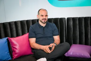 A man sitting with one leg crossed at the Houston lounge.