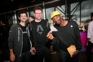 A group of men posing with the, "HTML IS FOR LOVERS," sticker.