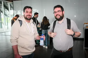 Two male guests pose together with their backpacks.