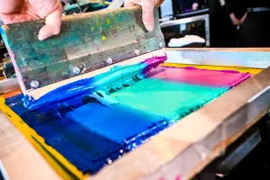 Closeup of the paint-like material used in a t-shirt printing press.