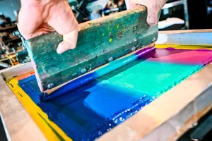 Closeup of the paint-like material used in a t-shirt printing press.