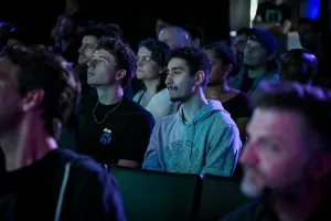 A shot of the crowd listening to Ben Holmes speak on stage.