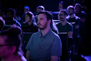 A shot of the crowd listening to Ben Holmes speak on stage.