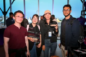 Guests pose for a group photo while holding their food.