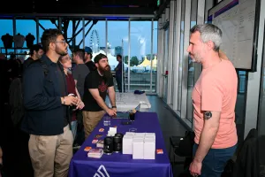 Guests listen intently as Sentry explains their product at their sponsor booth.