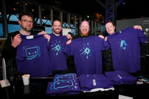 Astro team members holding up their purple printed Astro t-shirts. From left to right: Matt Kane (Houston), Ema Stoppa (Starlight logo), Nate (Starlight logo), and Chris Swithinbank (Astro logo).