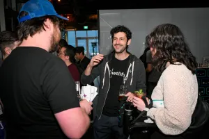 Guests chatting and holding drinks.