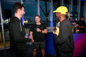 Guests chatting in front of the alcohol bar.