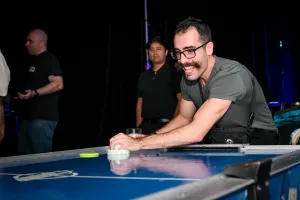 A guest playing air hockey.